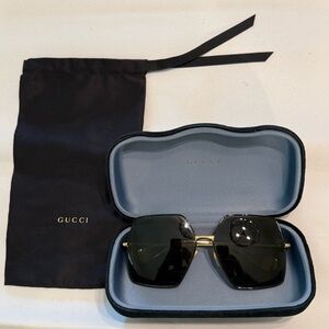 Gucci Sunglasses with Black Frames and Gold Details